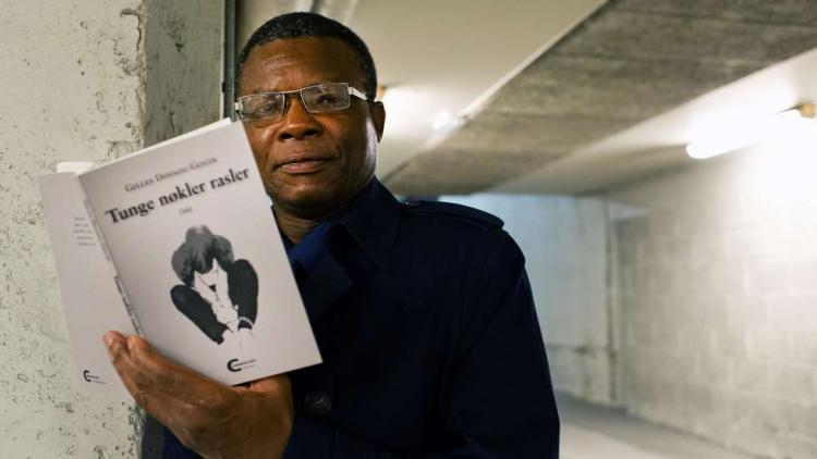 Gilles Dossou-Gouin was Moldes first ICORN writer-in-residence. He sadly passed away 30 September. Here with his latest poetry collection written in Norwegian. Foto: Kjell Langmyren. Photo.